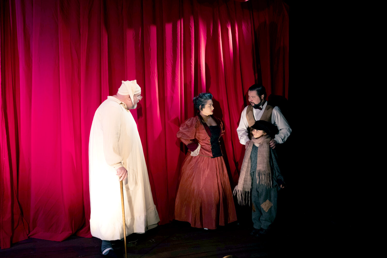 Scrooge (Paul Kiernan), Bob Cratchit (Brendan Chambers), Mrs. Crachit (Christa Holbrook) and Tiny Tim (Isabel Zamora). Courtesy photo